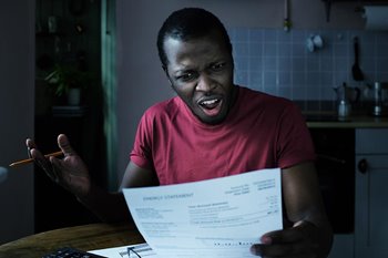 Young man looking at medical bill