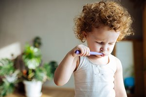 Young child brushing teeth