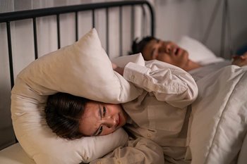 Person snoring keeping partner awake