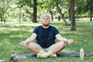 Man meditating in park