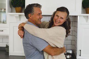 Happy husband and wife hugging