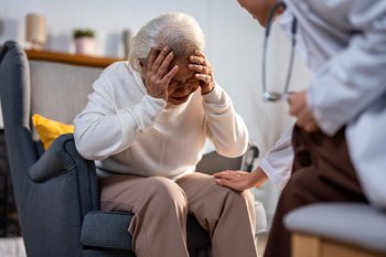 Doctor comforting elderly patient