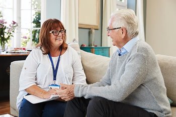 Therapist talking to senior man