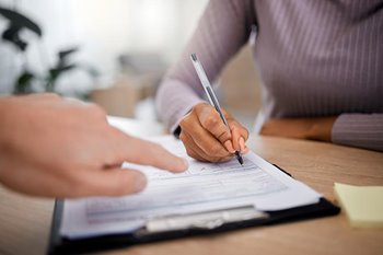 Person filling out healthcare documents