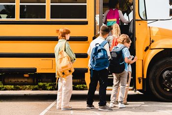 Children getting on school bus
