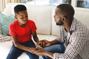 Father talking to young boy